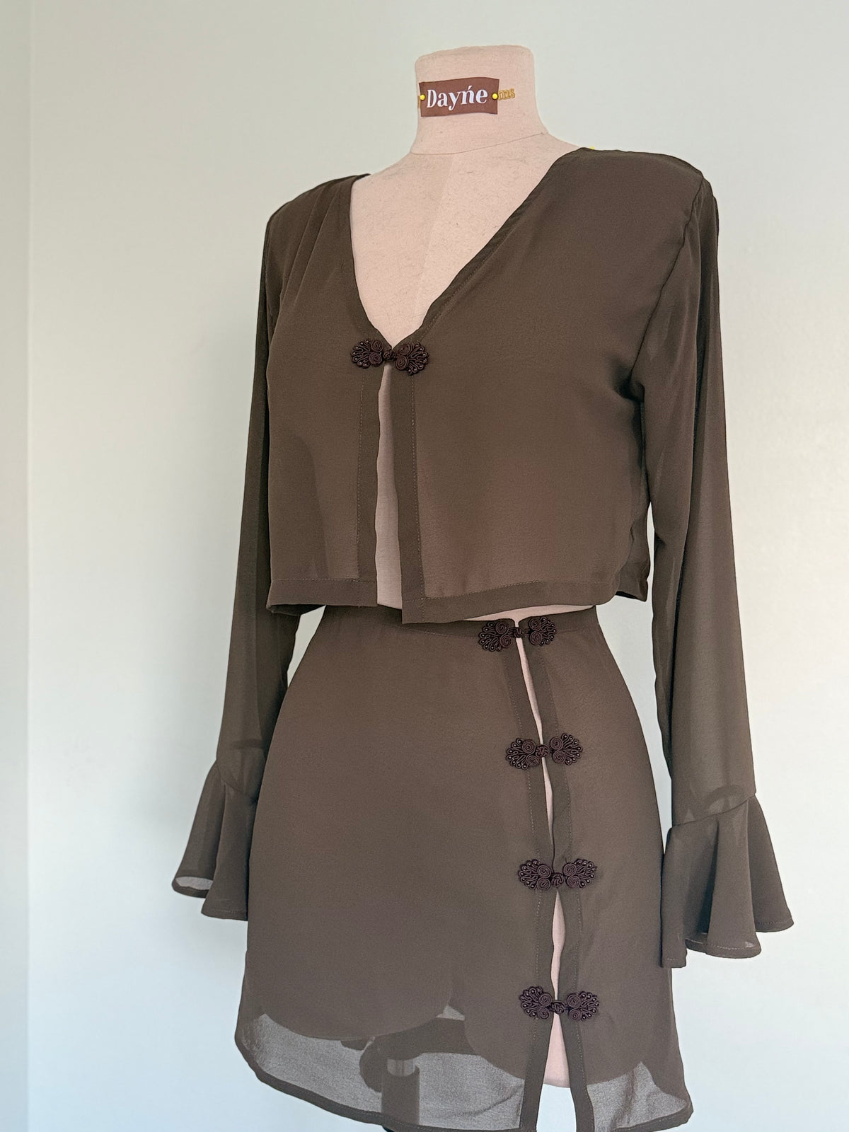 Brown outfit on a mannequin with a plain background