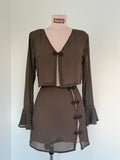 Brown dress on a mannequin with a plain background
