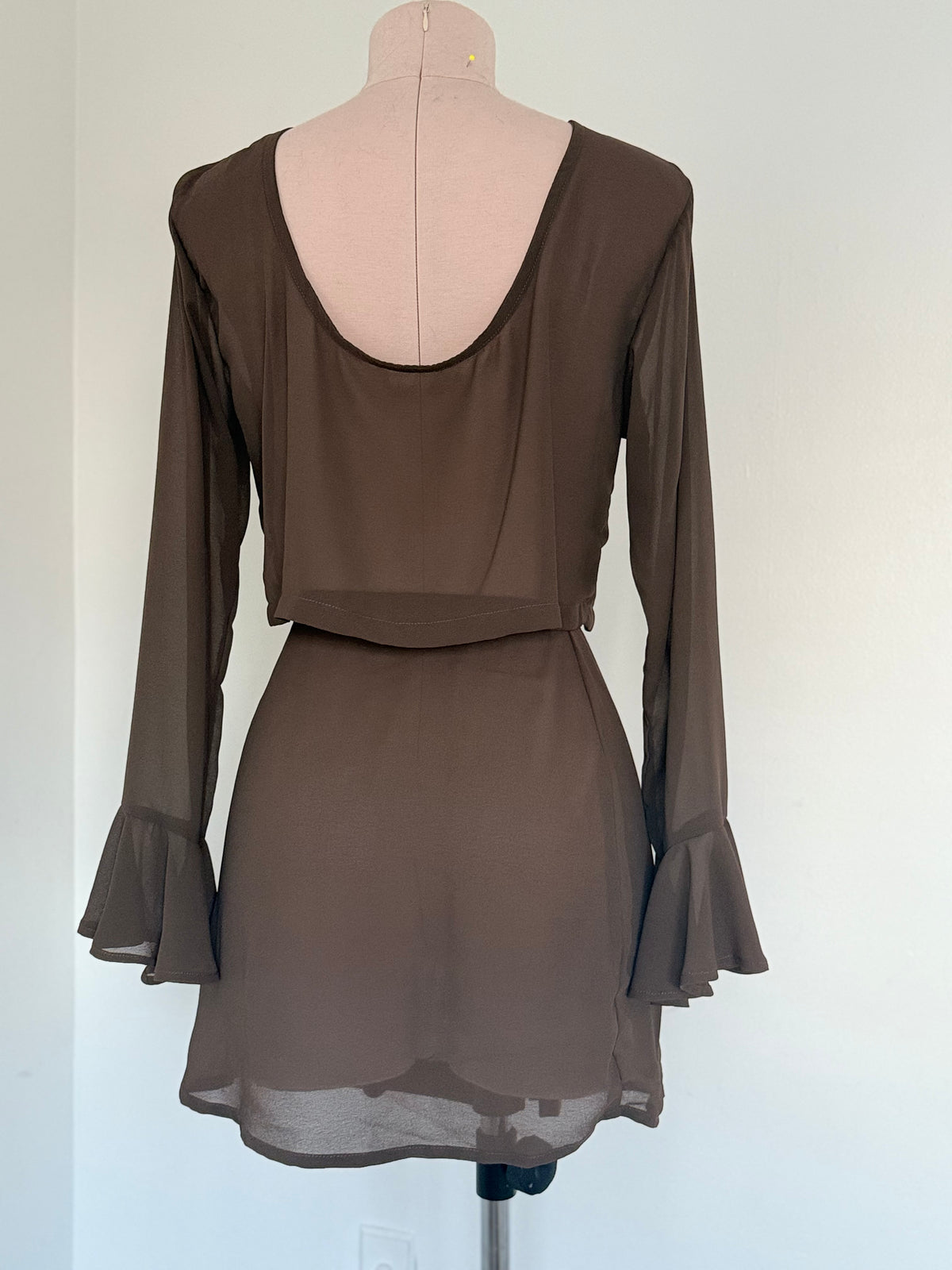 Brown dress on a mannequin against a white background